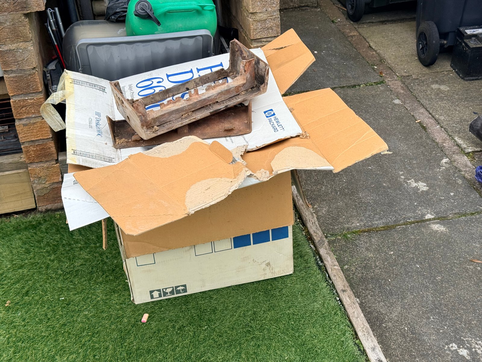 Old cast components sitting on cardboard