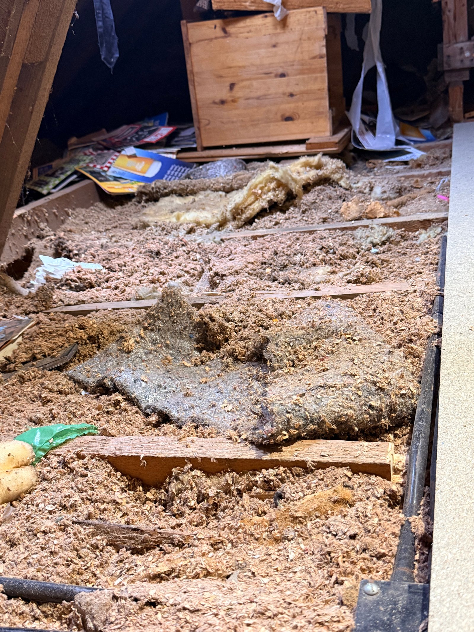 Sorting through old wood pieces and materials along the roof line