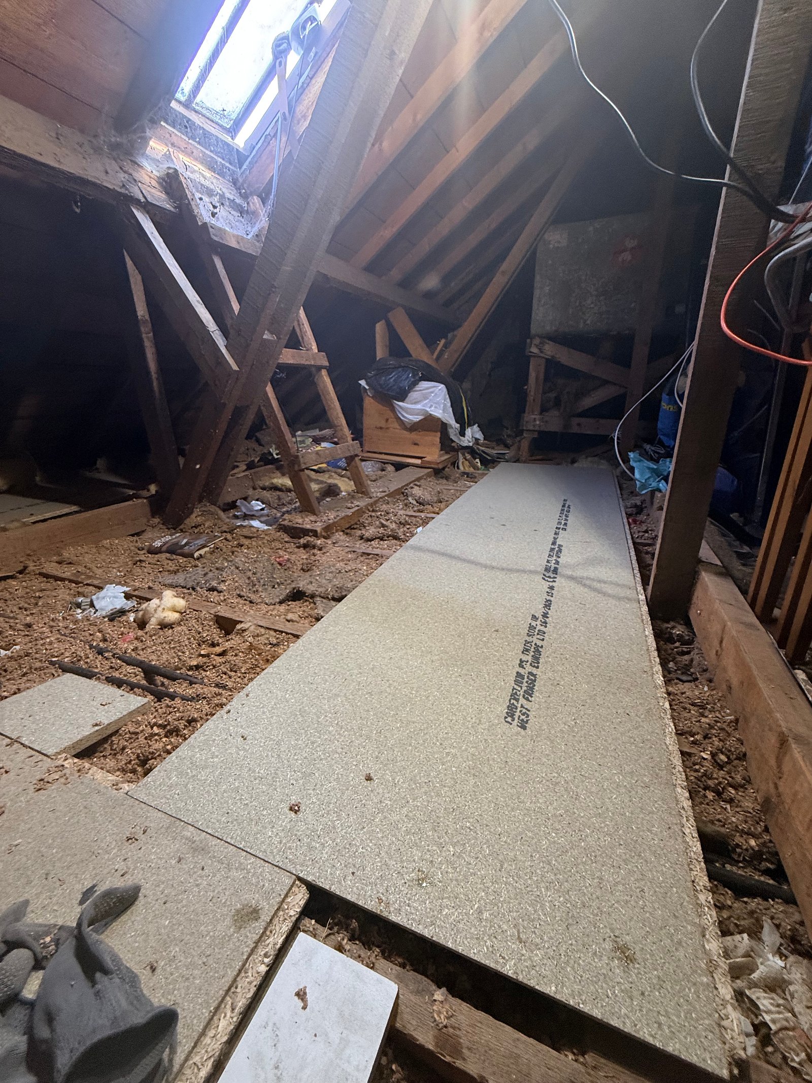 Locking down the first long run of fresh tongue and groove floor boards